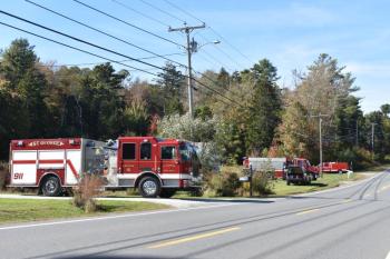 Fire trucks wait to be released from a shed fire