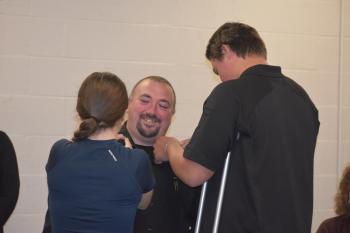 Eric Quatrano's children help with the pinning ceremony. (Photo by Sarah Thompson)