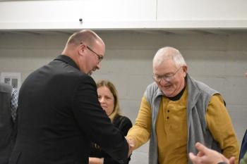 Paul Spear and Select Board member Peter Lammert shake hands. (Photo by Sarah Thompson)