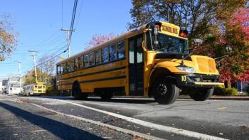 Maine has seen test scores drop on a national test for more than a decade. Data show that some of Maine’s most vulnerable students are falling the furthest. Photo by Kristian Moravec. school bus driving down a street.