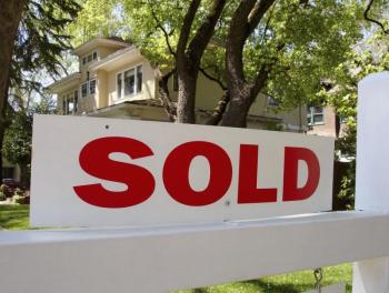 Photo credit: MetroCreative sold sign outside of a house.