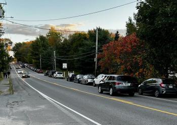 Cars park on either side of Route 1 in Rockport as the public takes an hour Wednesday evening, Oct. 1, to meet candidate Graham Platner.