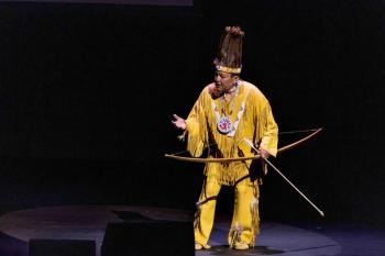 Passamaquoddy language teacher and cultural preservationist Dwayne Tomah performs onstage