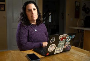 Carrie Woodcock, executive director of the Maine Parent Federation, sits at her kitchen table in Saco on October 23, where she works most days. Woodcock's organization provides free information, training and support to families of children with disabilities or special health care needs. She said she found declining school performance among students with disabilities and low incomes unsurprising, though she cautioned that testing doesn’t always show what students have learned. Photo by Troy R. Bennett. carrie woodcock sitting at a table.