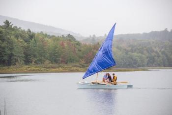 The catamaran, The Snail, sets sail with its test sail, a tarp. (Photo courtesy David Garrison)
