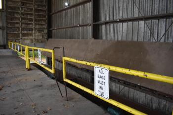 Barrier gates inside a garage. One of two metal pins is bent