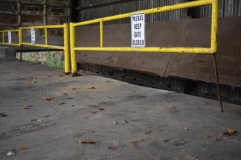 Tire marks and a sign that reads "Please keep gate closed"