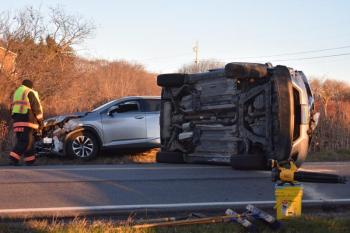Two vehicles, one on its side