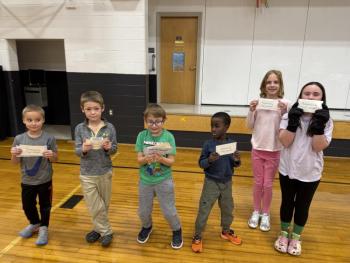 Six children, each holding envelopes 