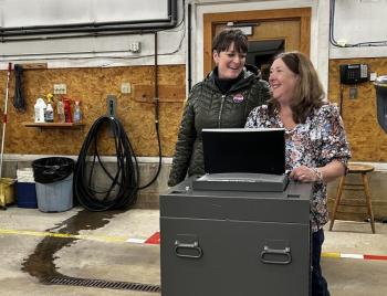 Camden Finance Director Jodi Hanson surprises Camden Town Clerk Katrina Oakes with a collective tribute Nov. 4, the last election that Oakes will oversee as Camden Town Clerk. (Photo by Lynda Clancy)