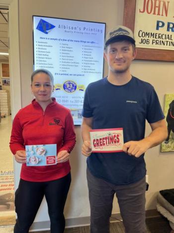 Female and male hold greeting cards