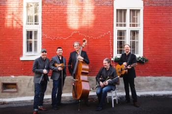Lunasa in front of red brick building