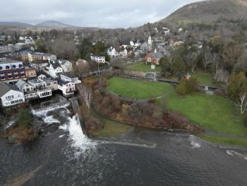 Photo taken in November 2023 during a stormy high tide event when the Camden Harbor Park seawall was breached and the shoreline flooded. Also pictured is the Megunticook River spillway and Montgomery Dam below the downtown commercial district.