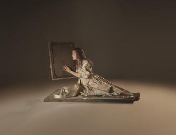 Female lounging, holding frame