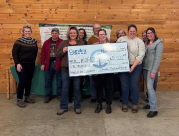 Group photo of an awardee and her oversized presentation check