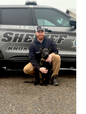 Man and dog pose in front of K9 cruiser