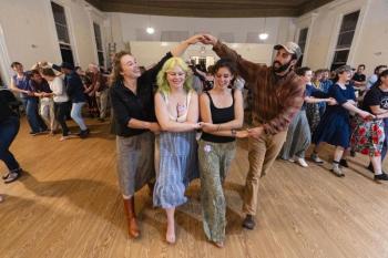 Four people dance together