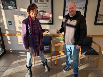 Woman and man pose with regular size check