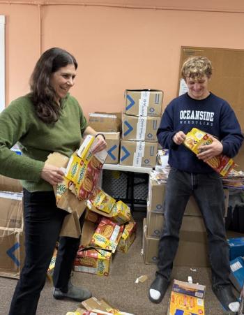 Woman, teenage boy flatten cardboard food packages