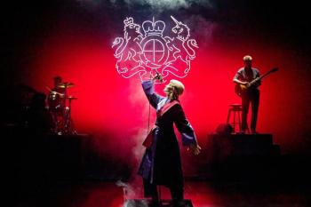 Singer on stage with red background
