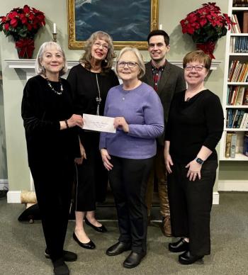 Four women, one man pose for check presentation
