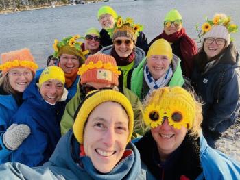 Group of women pose in selfie with yellow in their hats