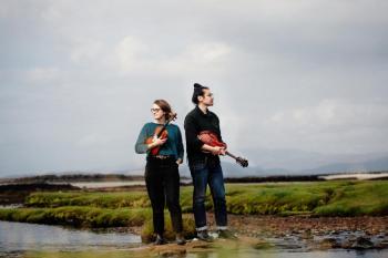 Two musicians standing in a marsh