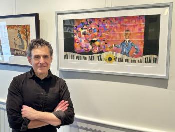 Man standing in front of framed prints
