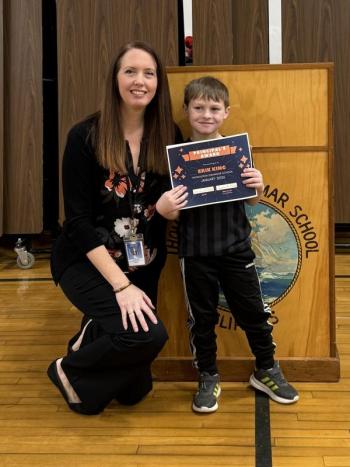 Adult and boy pose for a picture