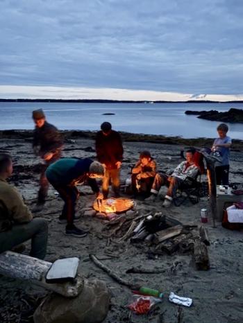 around a campfire on the beach