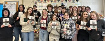 School class holds their copies of a book