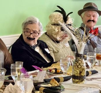 Two men, one woman in 1920s apparel