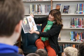 Woman reads from a picture book