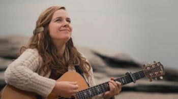 Alice Limoges strumming guitar