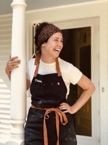 Woman leaning against post