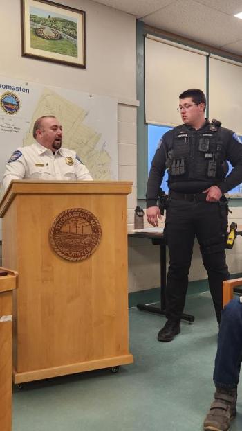 Chief behind podium recipient listens to the recognition