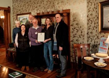 group photo next to pies on table