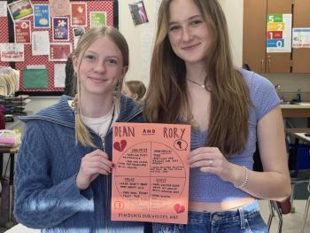 Two teen girls hold circle of control paper