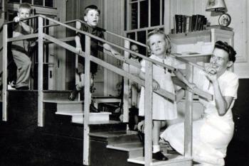 Children on stairs with nurse