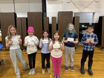 smaller group of students hold raffle wins
