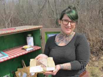 Whitney Brown by her Mossflower Cottage stand in Belmont. Photo by Kay Stephens