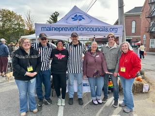 group photo including two men in referee shirts