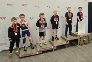 Leland Fields stands far right at the podium, with other competitors. (photo by Cody Laite)