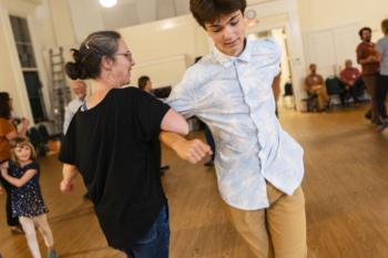 female and male turn during a dance