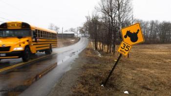 school bus driving down a street.