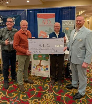 four men pose with oversize check 
