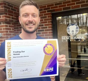 Robert Belanger holds Purple Ribbon Award certificate