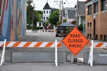 road closure sign, mural on left
