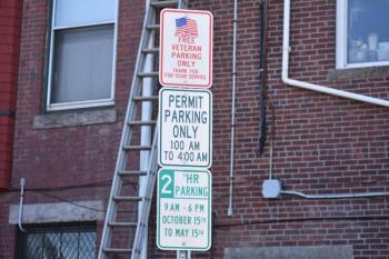 three signs on a vertical pole