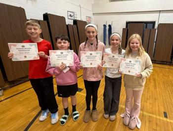 five kids stand with certificates